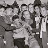 Basil Rathbone (center) surrounded by group of unidentified boys backstage during run of the stage production Sherlock Holmes