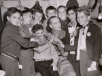 Basil Rathbone (center) surrounded by group of unidentified boys backstage during run of the stage production Sherlock Holmes