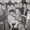 Basil Rathbone (center) surrounded by group of unidentified boys backstage during run of the stage production Sherlock Holmes