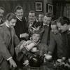Paul Henveid, Robert Donat, and others surrounding Greer Garson in the motion picture Goodbye, Mr. Chips
