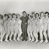 Publicity photo of Robert Taylor and chorus girls in the motion picture This is My Affair