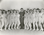 Publicity photo of Robert Taylor and chorus girls in the motion picture This is My Affair