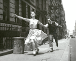 Carol Lawrence and Larry Kert running down the street in promotional photo for West Side Story.