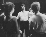Leonard Bernstein (with Carol Lawrence in background) instructing cast during rehearsal for West Side Story.