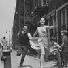 Larry Kert and Carol Lawrence running down the street in promotional photo for West Side Story.