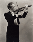 Guy Robertson as Johann Strauss, Jr. (on violin) in The Great Waltz.