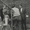 Michael J. Pollard (sitting on steps), Dick Van Dyke, and unidentified people outside theater during stage production Bye Bye Birdie