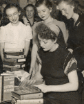 Gypsy Rose Lee autographing copies of her novel, The G-String Murders