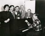 Betty Comden, Rosalind Russell, Adolph Green, George Abbott, Lehman Engel, and Leonard Bernstein (at piano) in rehearsal for the stage production Wonderful Town, 1953.