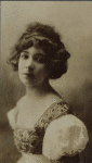 Thamara de Svirsky, half portrait, wearing embroidered bodice with puff sleeves.