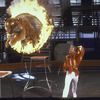 Tiger leaps through flaming hoop with trainer Nikolai Pavenko of Moscow Circus during performance set up for photographer.