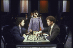 Actors Philip Casnoff and David Carroll playing chess as actress Judy Kuhn (C) looks on, in scene from Broadway musical "Chess."