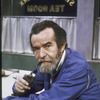 Playwright Athol Fugard in casual jacket, smoking pipe at St. George's Park Tea Room.