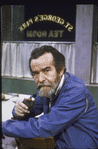 Playwright Athol Fugard in casual jacket, smoking pipe at St. George's Park Tea Room.