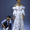 Full length shot of Vanessa Williams in costume (elaborate white ruffled dress) for role in show "One Man Band" with unidentified actor sitting in background.