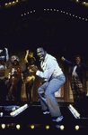 Ben Vereen singing, with line of dancers behind him, in musical.