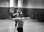 Choreographer Jerome Robbins leading ballerina in rehearsal.