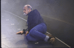 Director/choreographer Bob Fosse laying on stage floor during filming of television commerical for the revival of the Broadway musical "Sweet Charity." (New York)