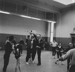 New York City Ballet rehearsal of "La Valse" with choreographer George Balanchine assisting with Patricia McBride in lift (New York)