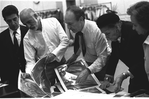 New York City Ballet rehearsal room, unidentified dancer, Jerome Robbins, George Balanchine and costumer Barbara Karinska looking at Nicholas Benois' sketches for "Theme and variations", choreography by George Balanchine (New York)