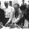 New York City Ballet rehearsal room, unidentified dancer, Jerome Robbins, George Balanchine and costumer Barbara Karinska looking at Nicholas Benois' sketches for "Theme and variations", choreography by George Balanchine (New York)