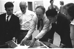 New York City Ballet rehearsal room, unidentified dancer, Jerome Robbins, George Balanchine and costumer Barbara Karinska looking at Nicholas Benois' sketches for "Theme and variations", choreography by George Balanchine (New York)