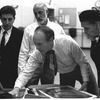 New York City Ballet rehearsal room, unidentified dancer, Jerome Robbins, George Balanchine and costumer Barbara Karinska looking at Nicholas Benois' sketches for "Theme and variations", choreography by George Balanchine (New York)