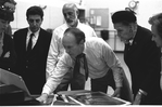 New York City Ballet rehearsal room, unidentified dancer, Jerome Robbins, George Balanchine and costumer Barbara Karinska looking at Nicholas Benois' sketches for "Theme and variations", choreography by George Balanchine (New York)