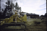 New York City Ballet dancer Violette Verdy poses on a tractor amidst the construction of the new Saratoga Performing Arts Center (Saratoga)