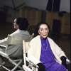 Portrait of choreographer Martha Graham sitting in front of mirror in rehearsal room