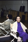 Portrait of choreographer Martha Graham sitting in front of mirror in rehearsal room