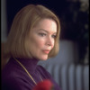 Actress Ellen Burstyn sitting near bouquet of flowers