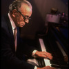 Musician Larry Adler at piano. (New York)