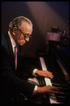 Musician Larry Adler at piano. (New York)