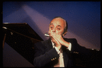 Musician Larry Adler playing the harmonica. (New York)