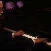 Musician Larry Adler at the piano. (New York)