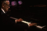 Musician Larry Adler at the piano. (New York)