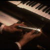 Hands of musician Larry Adler holding a harmonica. (New York)