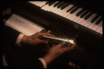 Hands of musician Larry Adler holding a harmonica. (New York)