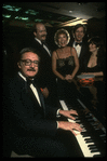 Publicity shot of comedian/musician Steve Allen (L) with unident. singers (New York)