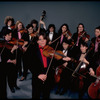 Studio publicity photograph of conductor Marin Alsop (C) with musical group "String Fever" (New York)