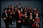 Studio publicity photograph of conductor Marin Alsop (C) with musical group "String Fever" (New York)