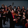Studio publicity photograph of conductor Marin Alsop (C) with musical group "String Fever" (New York)