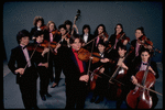 Studio publicity photograph of conductor Marin Alsop (C) with musical group "String Fever" (New York)