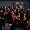 Studio publicity photograph of conductor Marin Alsop (C) with musical group "String Fever" (New York)