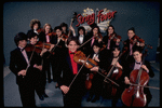 Studio publicity photograph of conductor Marin Alsop (C) with musical group "String Fever" (New York)