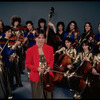 Studio publicity photograph of conductor Marin Alsop (C) with musical group "String Fever" (New York)