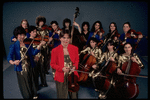 Studio publicity photograph of conductor Marin Alsop (C) with musical group "String Fever" (New York)