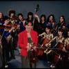 Studio publicity photograph of conductor Marin Alsop (C) with musical group "String Fever" (New York)