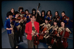 Studio publicity photograph of conductor Marin Alsop (C) with musical group "String Fever" (New York)